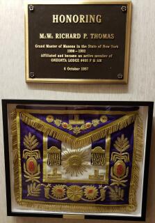 MW Richard Thomas' Grand Master Apron mounted below his plaque in the second floor hallway.